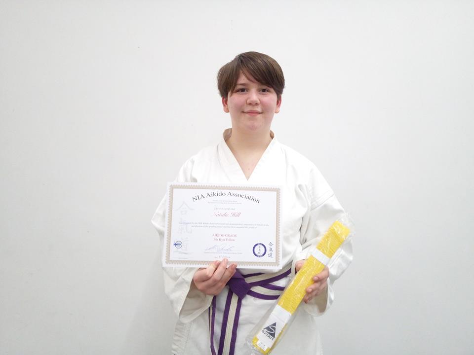 Natalie receiving her yellow belt