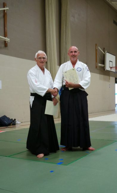 Shihan Kevin Christie receiving a certificate of appreciation from Shihan Terry Bayliss for teaching at Seijitsu Aikido ryu summer school 2013