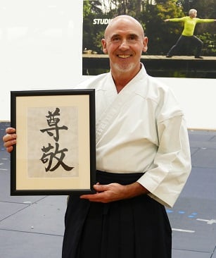 Shihan Kevin Christie with gift given to him by Nia Aikido students and dan grades for his 60th Birthday